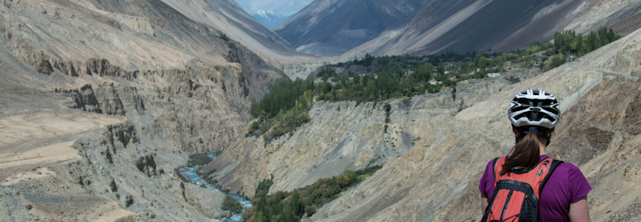 Cyclist admiring the view on the Kyrgyzstan Karakoram Highway Cycling Tour