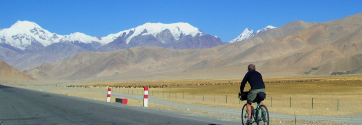 Cycling along the vast plains of Kyrgyzstan during the Karakoram Highway Cycling Tour