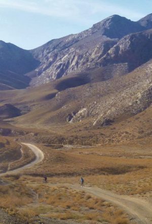 cycling through a valley through our tour of Uzbekistan