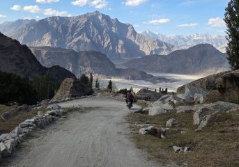 A dirt road passing through the mountainous landscape of the Hunza Valley